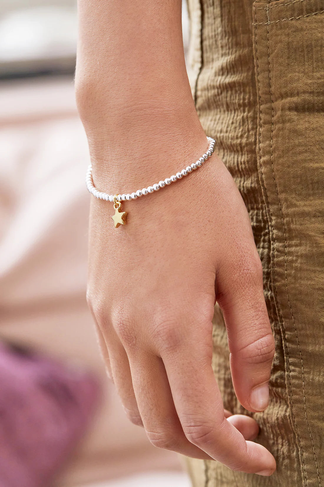 Estella Bartlett puffed star Sienna bracelet with gold-tone chain and star charm, stylish jewelry accessory.