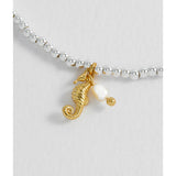 Estella Bartlett Seahorse and Pearl Sienna bracelet featuring a delicate seahorse charm and pearl accents on a silver chain.