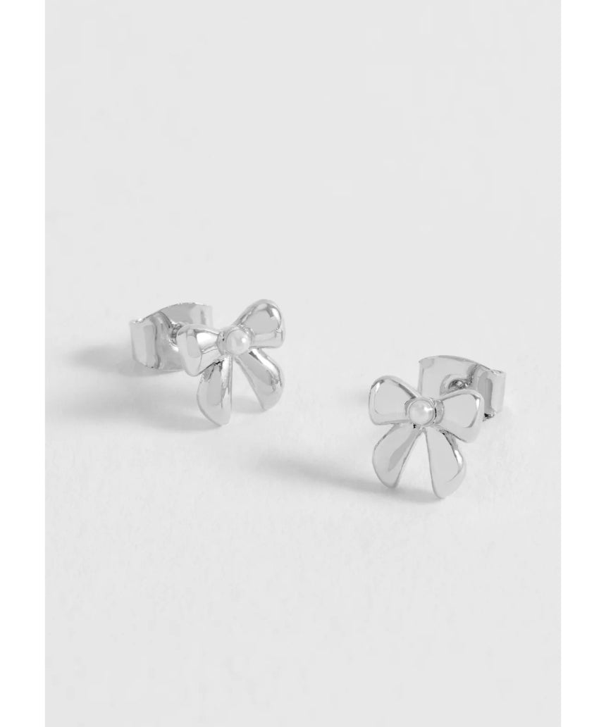 Silver Estella Bartlett pearl bow stud earrings with delicate design and shiny finish, featuring elegant pearl accents.