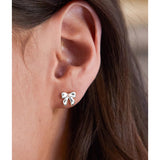 Silver pearl bow stud earrings by Estella Bartlett featuring elegant pearl and bow design for a sophisticated look.