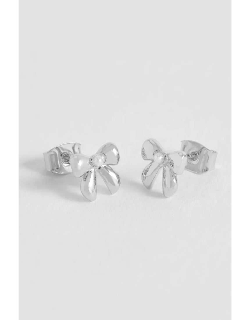Silver Estella Bartlett pearl bow stud earrings featuring elegant pearl accents and delicate bow design.