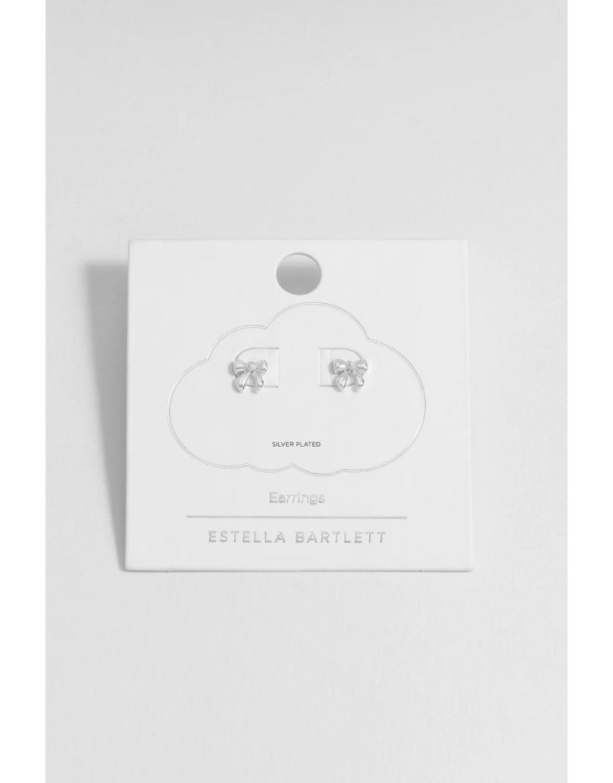 Silver pearl bow stud earrings by Estella Bartlett featuring elegant pearl accents and delicate bow design.