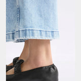 Black Elk Kuren flat shoes with sleek design, featuring comfortable slip-on style and subtle detailing.