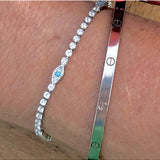 Salty Safari Evil Eye Protection Tennis Bracelet featuring a silver chain with colorful evil eye charms on a white background.