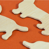 Set of Suck UK fridge magnets featuring colorful cartoon dogs with playful expressions on a metallic surface.