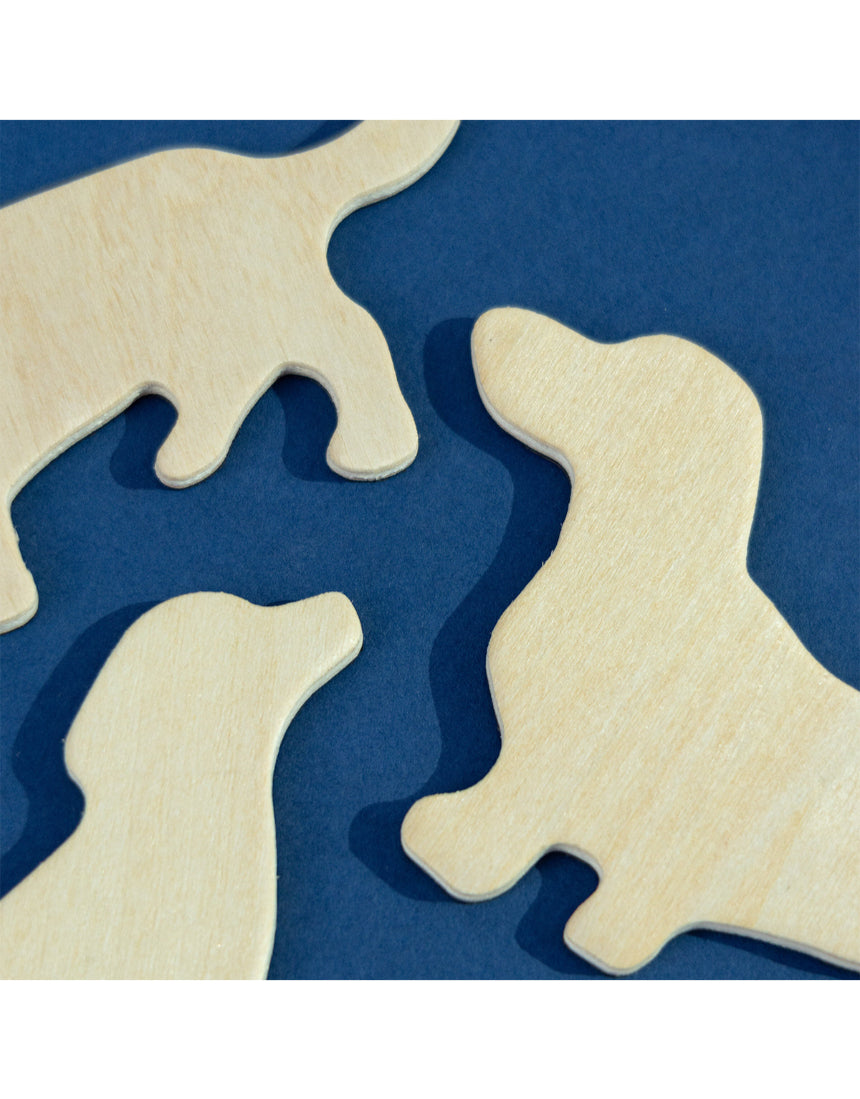 Set of Suck UK fridge magnets featuring colorful dog illustrations on a metallic surface.