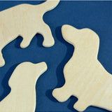 Set of Suck UK fridge magnets featuring colorful dog illustrations on a metallic surface.