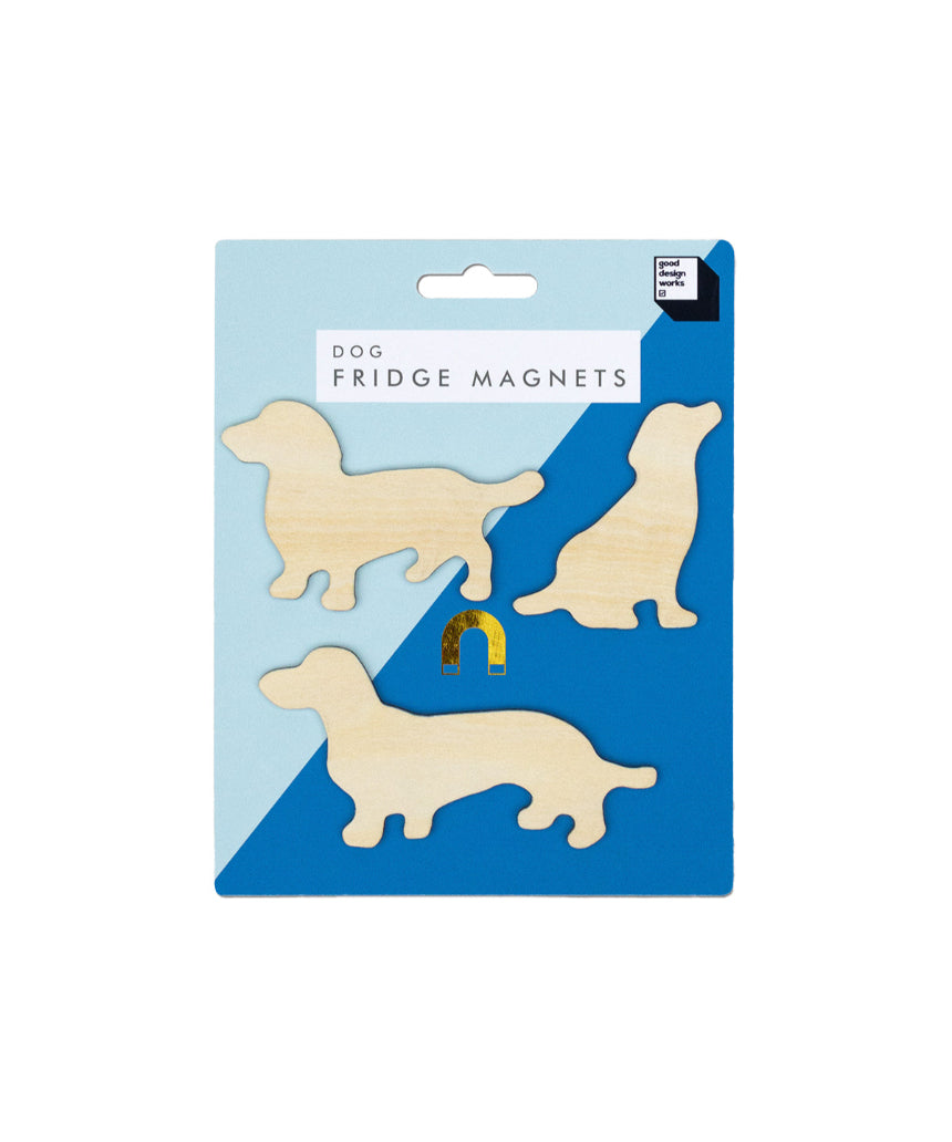 Set of Suck UK fridge magnets featuring playful dog designs on a metallic surface.