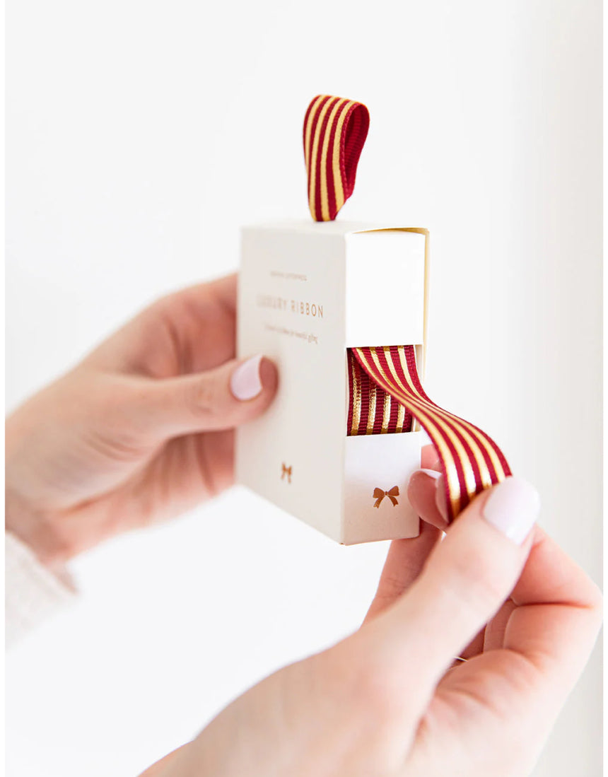 Red and gold foil striped ribbon by Bespoke Letterpress, 10 meters, showcasing its vibrant, metallic design and smooth texture.