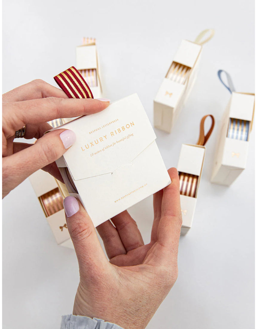 Red and gold foil striped ribbon from Bespoke Letterpress, 10 meters, showcasing elegant decorative ribbon for craft and gift wrapping.