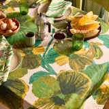 Bonnie and Neil Gem Green glass tumbler with a smooth, rounded shape, displayed on a dining table setting.