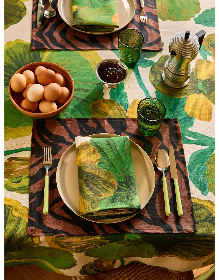 Bonnie and Neil Gem Green glass tumbler with a smooth, rounded shape, displayed on a dining table setting.