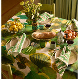 Bonnie and Neil Gem Green glass tumbler with a smooth surface, shown on a dining room table setting.