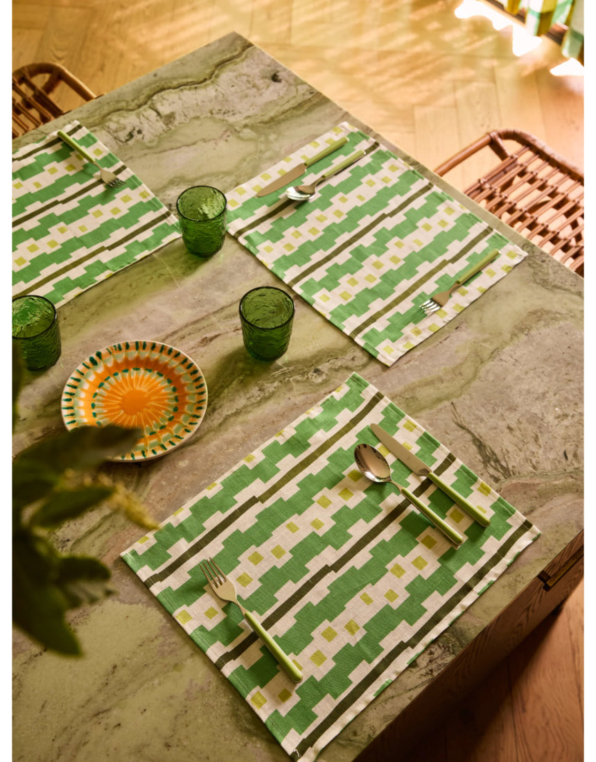 Bonnie and Neil Gem Green glass tumbler with a smooth, rounded shape, displayed on a dining room table setting.