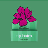 Green peppermint lip balm tube from Bloom & Body with a sleek green packaging and clear branding.
