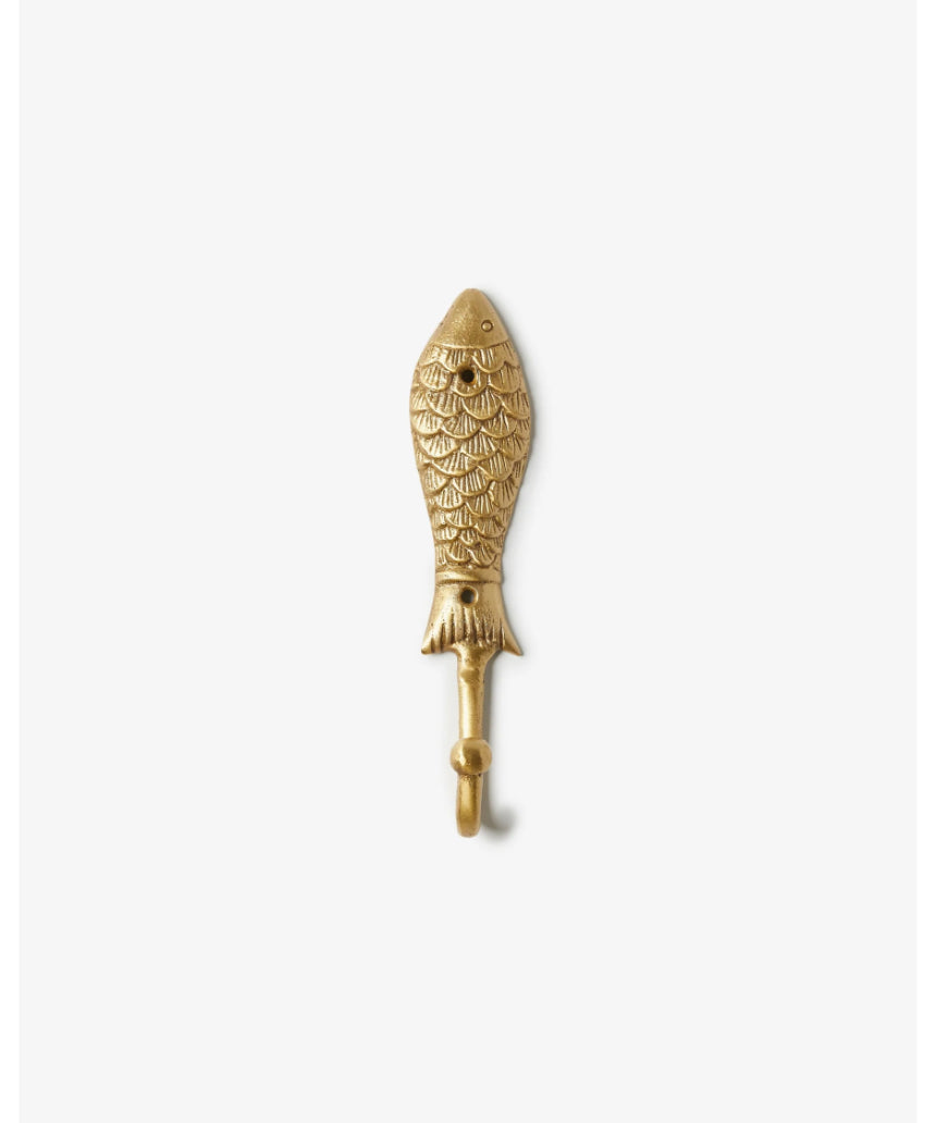 Brass fish-shaped wall hook by Bonnie and Neil mounted on a wall, featuring a sleek, decorative design for hanging items.