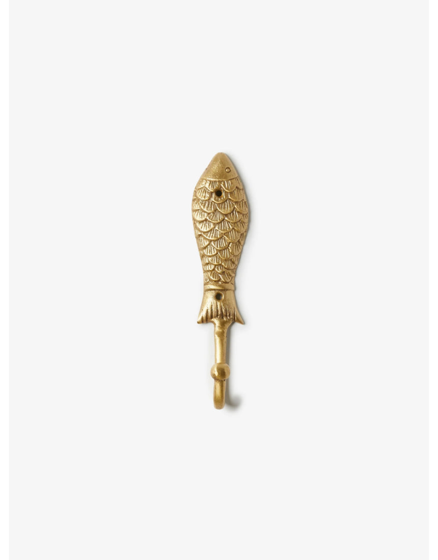 Brass fish-shaped wall hook by Bonnie and Neil mounted on a wall, featuring a sleek, decorative design for hanging items.