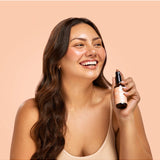 Lula Happy Mist essential oil bottle with a sleek design, featuring vibrant labels and a spray nozzle for aromatic use.
