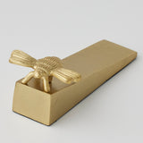 Gold Pilbeam Living Bee Door Wedge with detailed bee design and sturdy wedge shape for keeping doors open or closed.