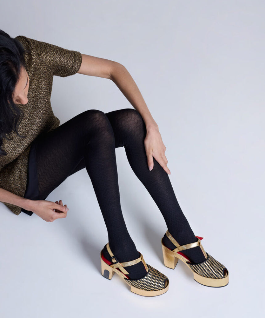 Black Herringbone Merino Wool Tights by Tightology, close-up of the textured pattern and snug fit on the legs.