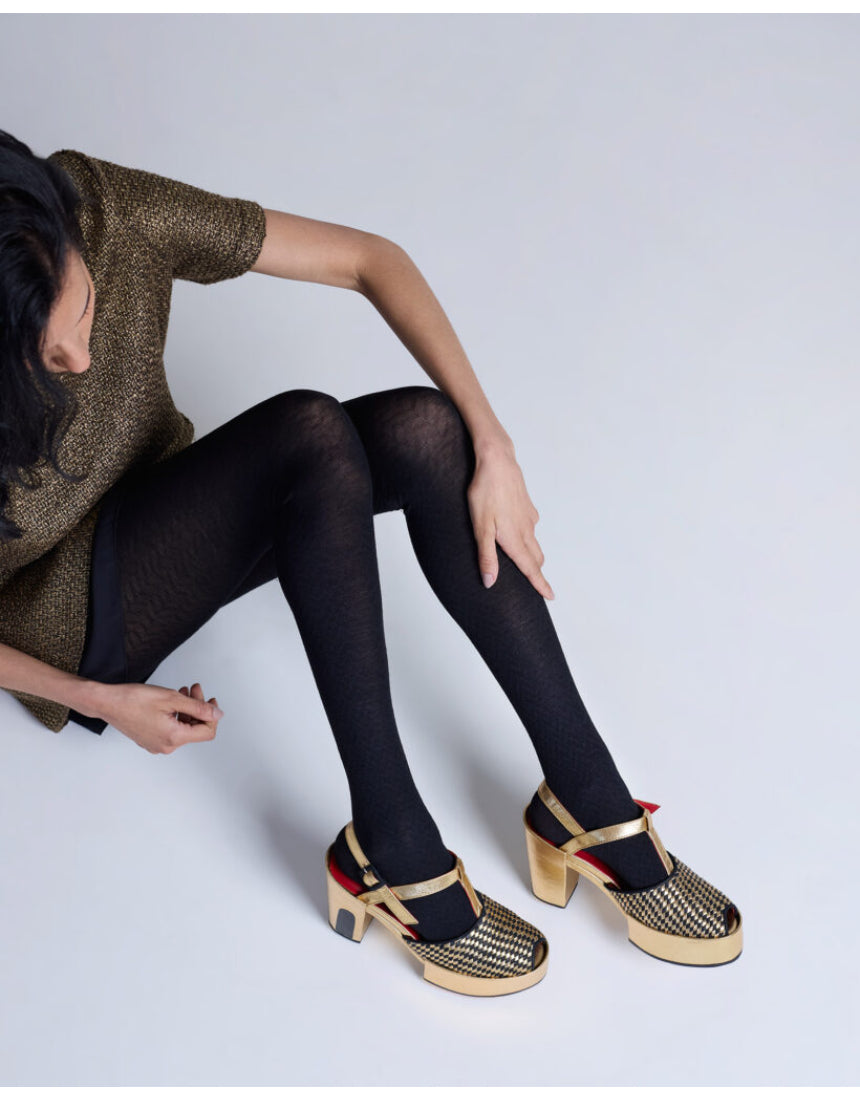 Black Herringbone Merino Wool Tights by Tightology, close-up of the textured pattern and snug fit on the legs.