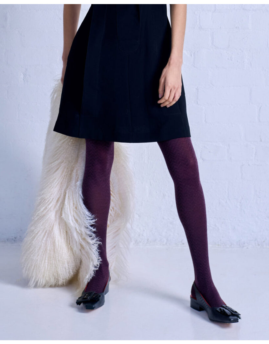Close-up of Tightology Herringbone Merino Wool Tights showing the textured herringbone pattern and soft wool fabric.