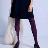 Close-up of Tightology Herringbone Merino Wool Tights showing the textured herringbone pattern and soft wool fabric.