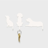 Suck UK Hooks Dog wall hook shaped like a playful dog figure, made of metal, used for hanging coats or accessories.