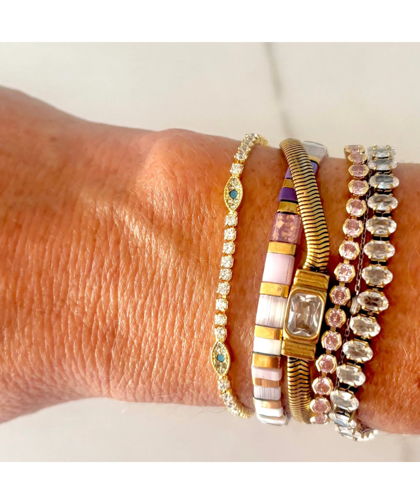 Salty Safari Evil Eye Protection Tennis Bracelet featuring colorful beads and a central evil eye charm on a stretch bracelet.
