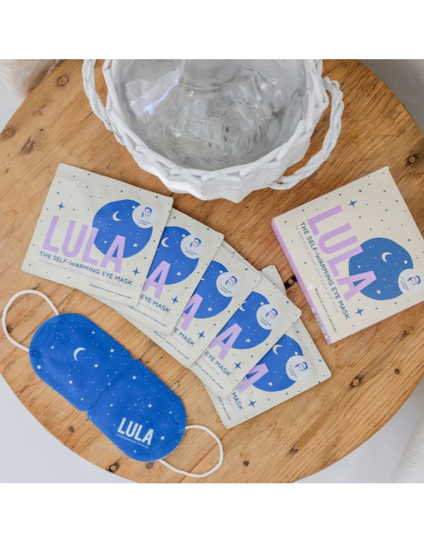 Lula self-warming lavender eye mask, soft fabric covering the eyes, designed for relaxation and soothing sleep.