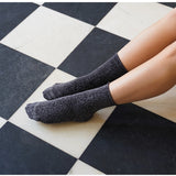 Grey glitter Lurex socks by Klue with a shiny, textured sock design, showcasing a stylish and comfortable fit.