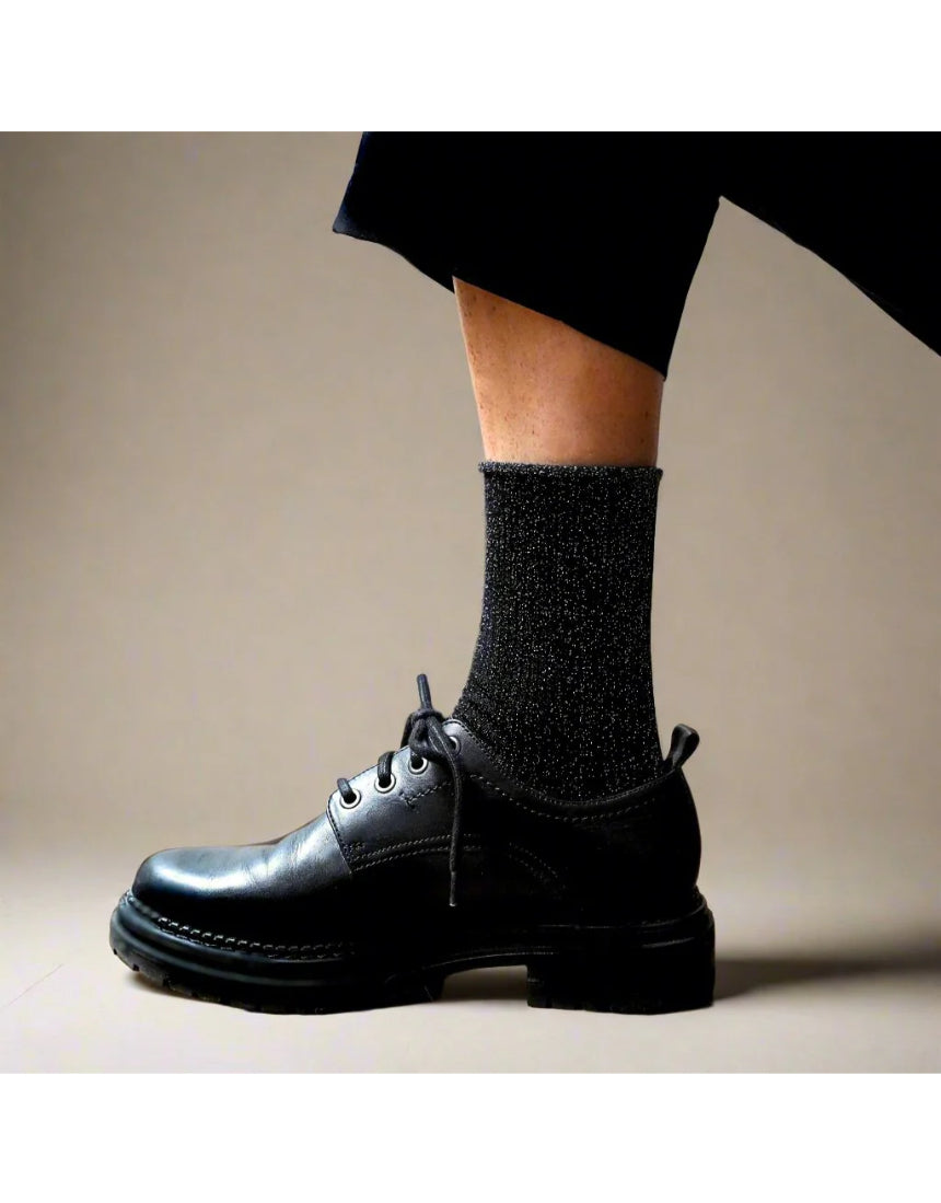 Black glitter lurex socks by Klue featuring shiny, textured fabric and a classic sock design.