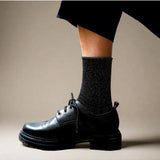 Black glitter lurex socks by Klue featuring shiny, textured fabric and a classic sock design.