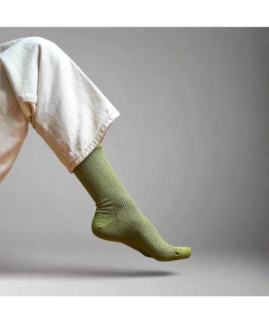 Olive green glitter lurex socks by Klue featuring a soft, shiny fabric and cozy fit, perfect for stylish comfort.
