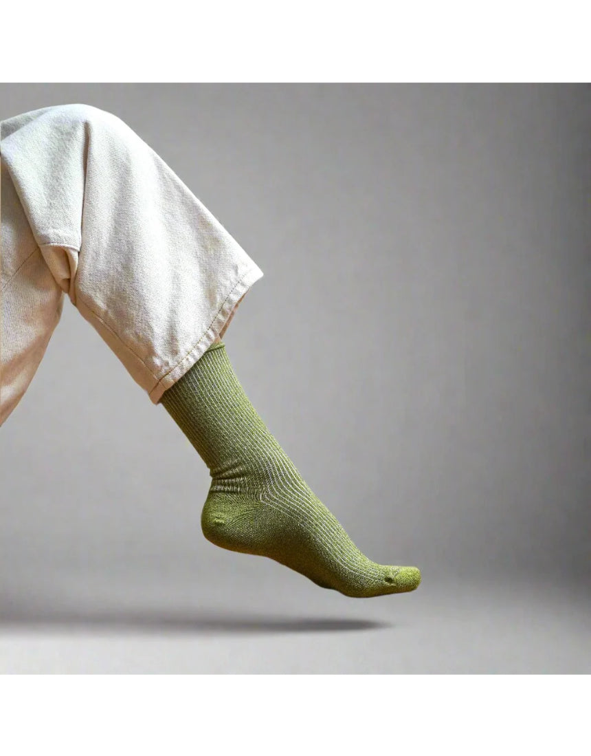 Olive green glitter lurex socks by Klue featuring a soft, shiny fabric and cozy fit, perfect for stylish comfort.