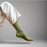 Olive green glitter lurex socks by Klue featuring a soft, shiny fabric and cozy fit, perfect for stylish comfort.