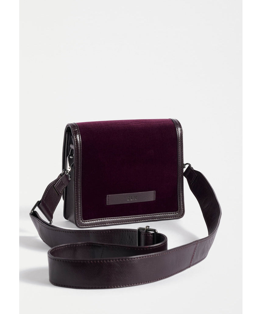 ELK The Label Vel crossbody bag in mulberry leather, featuring a sleek design and adjustable strap, on a plain background.