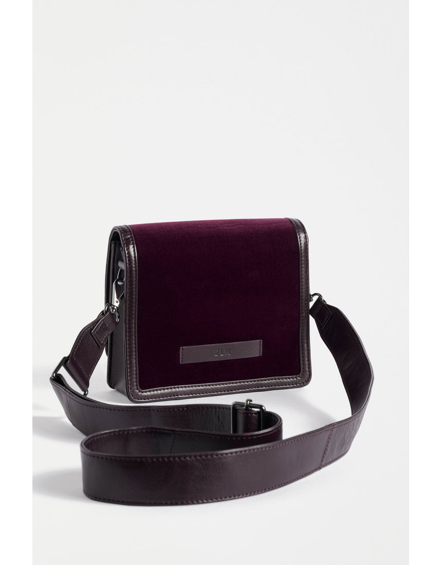 ELK The Label Vel crossbody bag in mulberry leather, featuring a sleek design and adjustable strap, on a plain background.