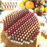 Luk Beautifood Lip Nourish lipstick in Ruby Grapefruit with natural pink and coral tones, shown in a sleek tube.