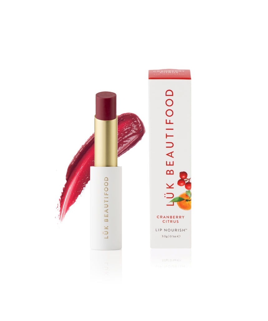 Luk Beautifood Lip Nourish cranberry citrus lipstick in a sleek tube with vibrant red and orange shades.