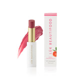 Luk Beautifood Lip Nourish lipstick in Ruby Grapefruit with vibrant orange-red shade and sleek packaging.