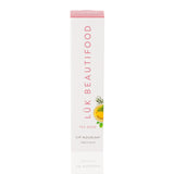 Luk Beautifood Lip Nourish lipstick in Tea Rose shade, showcasing the natural pink lipstick tube with a clear cap and floral branding.