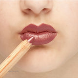Lük Beautifood Natural Lipstick Crayon in Berry Bite applied on lips, showcasing rich berry color and smooth finish.