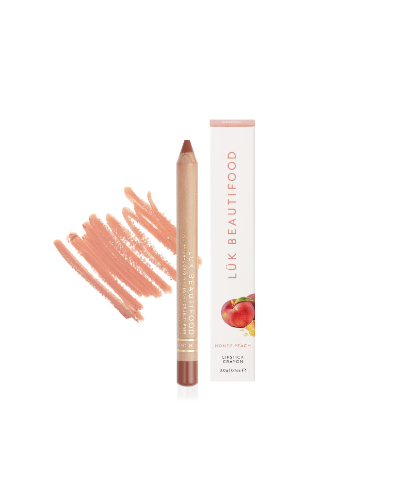 Lük Beautifood Natural Lipstick Crayon in Honey Peach with packaging, showing the peach-toned lipstick and box.
