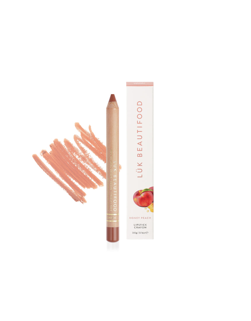 Lük Beautifood Natural Lipstick Crayon in Honey Peach with packaging, showing the peach-toned lipstick and box.