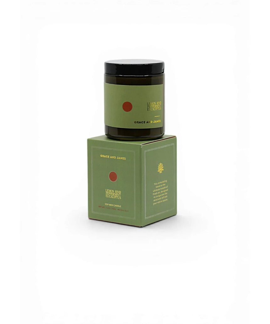 Grace & James Forager Candle with lemon rind, peppermint, and eucalyptus showing a white candle in a glass jar with fresh herbs