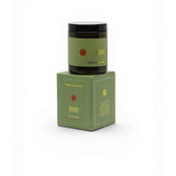 Grace & James Forager Candle with lemon rind, peppermint, and eucalyptus showing a white candle in a glass jar with fresh herbs