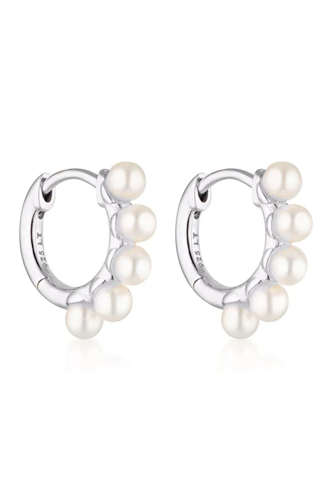 Linda Tahija Wake Pearl silver huggie earrings featuring small pearl accents and sleek hoop design.