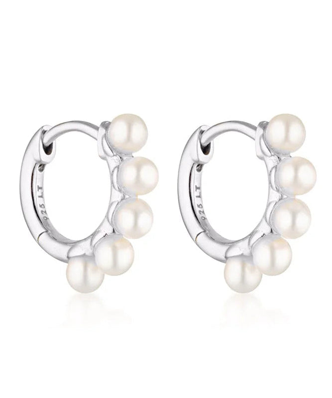 Linda Tahija Wake Pearl silver huggie earrings featuring small pearl accents and sleek hoop design.