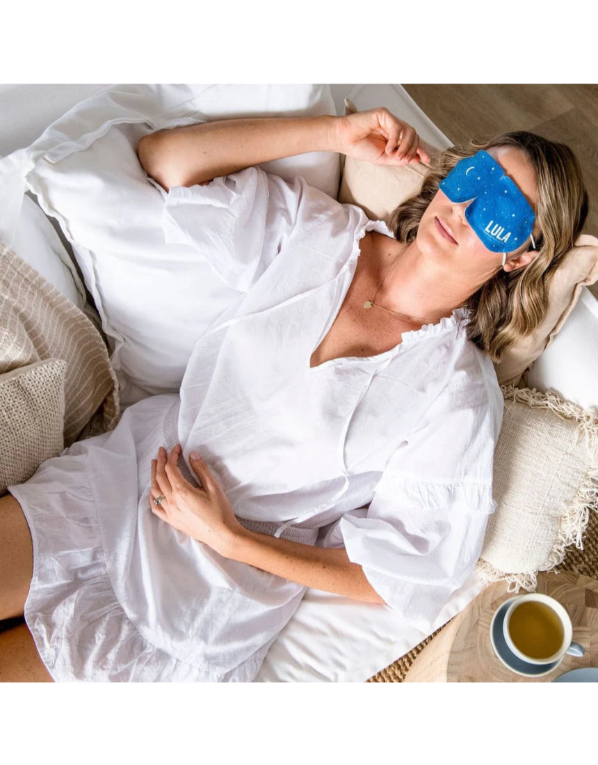Lula self-warming eye mask in jasmine scent, soft fabric, designed to soothe and relax the eyes, shown in a close-up image.